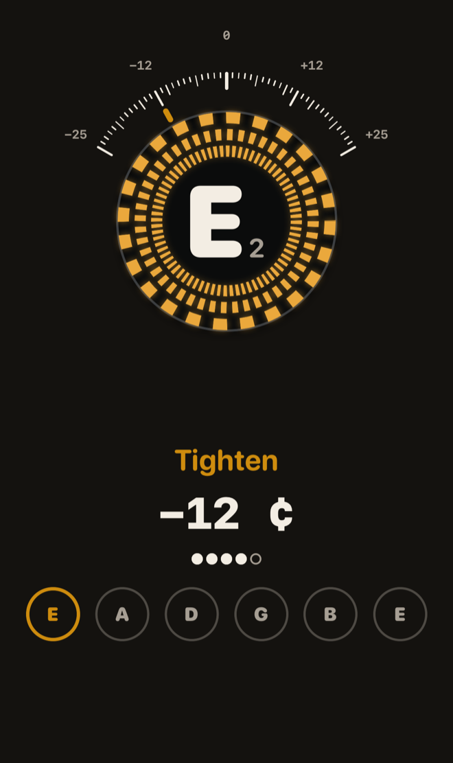 The strobe design at night: amber and black rings around a large E, under an arc scale from −25 to +25 cents.
