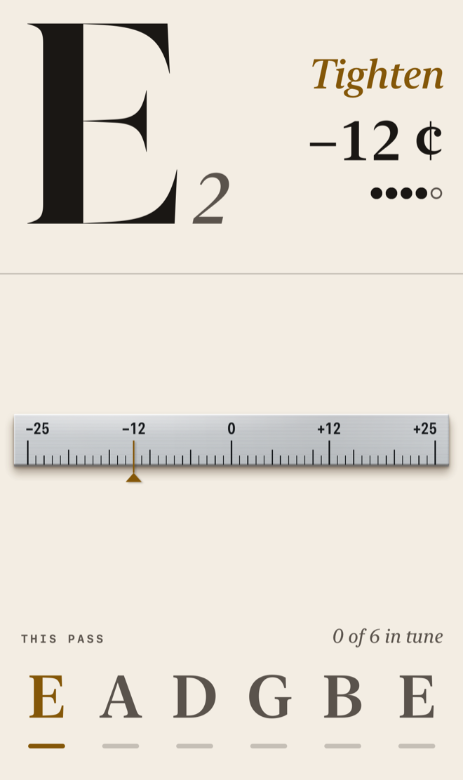 The tuner reading low E, twelve cents flat: a large E with a small 2, the word Tighten, and −12 ¢ above an amber marker on a steel rule.